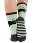 Pair of socks with black and white designs on a light green background