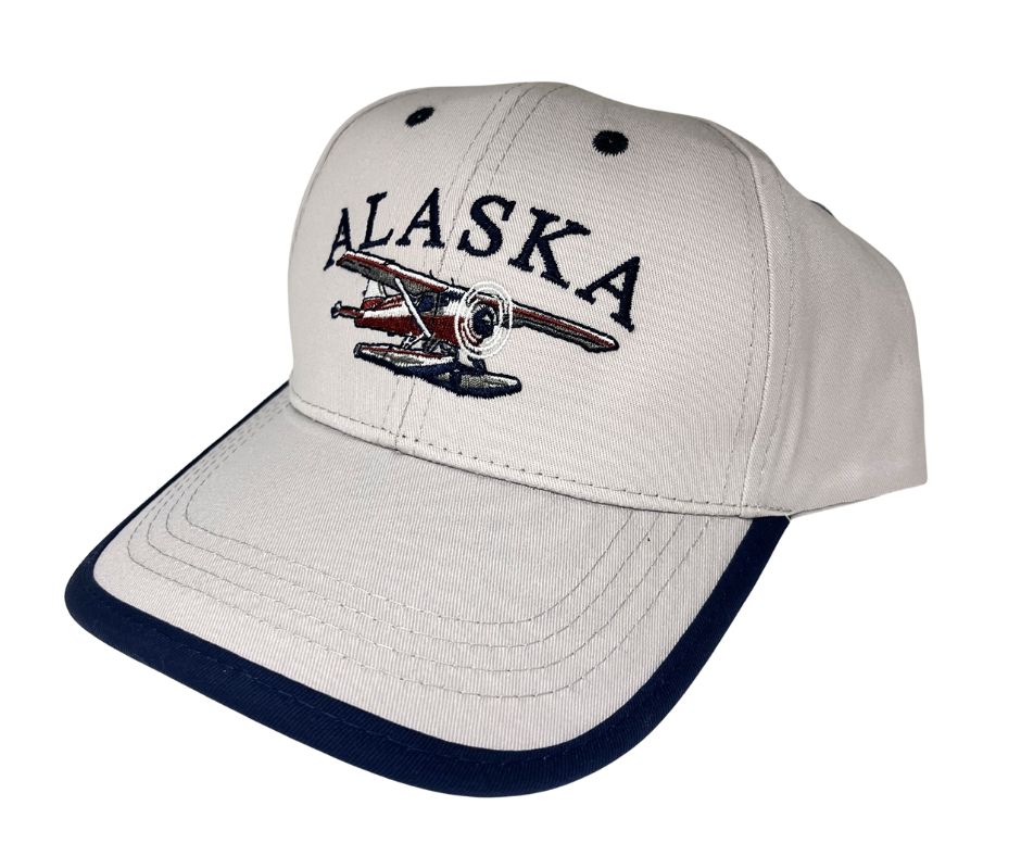 Cap with 'Alaska' and airplane design on a white background