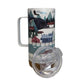 Travel mug with a scenic design featuring mountains, trees, and buildings