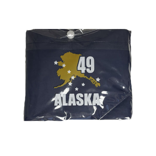 Packaged poncho with 'Alaska 49' design on a blue background