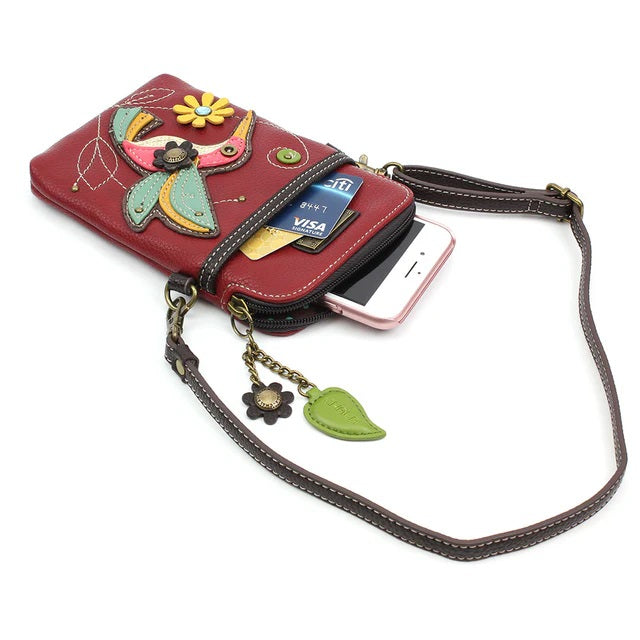 An open crossbody bag with a zipper, showing with credit cards and a phone coming out of the pocket