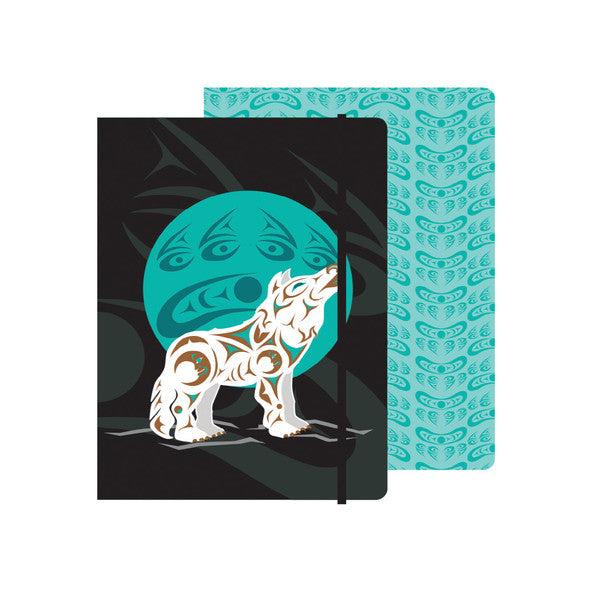Notebook with wolf and moon design on black cover and teal patterned back