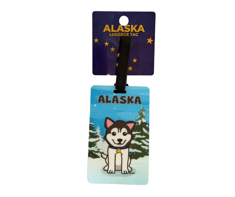Luggage tag featuring a cute husky sitting in snow, with trees in the background