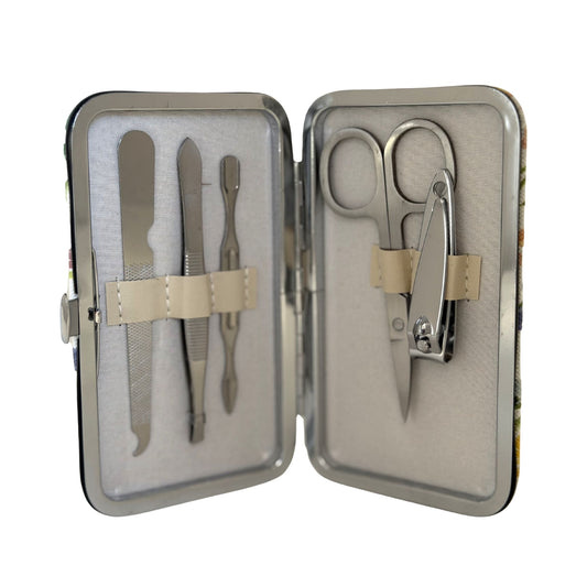 Manicure set with scissors, nail clippers, and files in a metal case