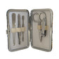 Manicure set with scissors, nail clippers, and files in a metal case