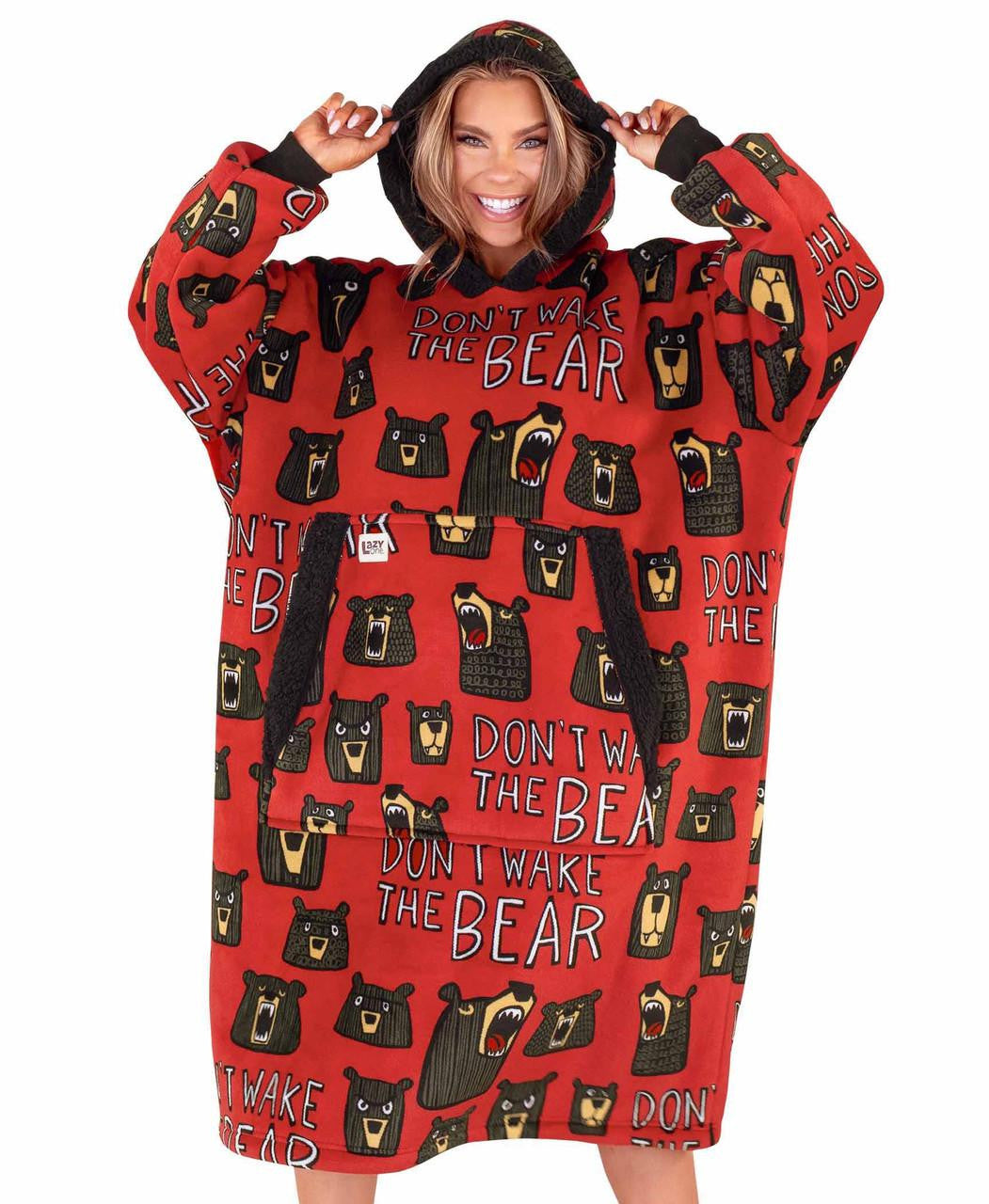 Person wearing a red hoodie with bear pattern and text on a white background