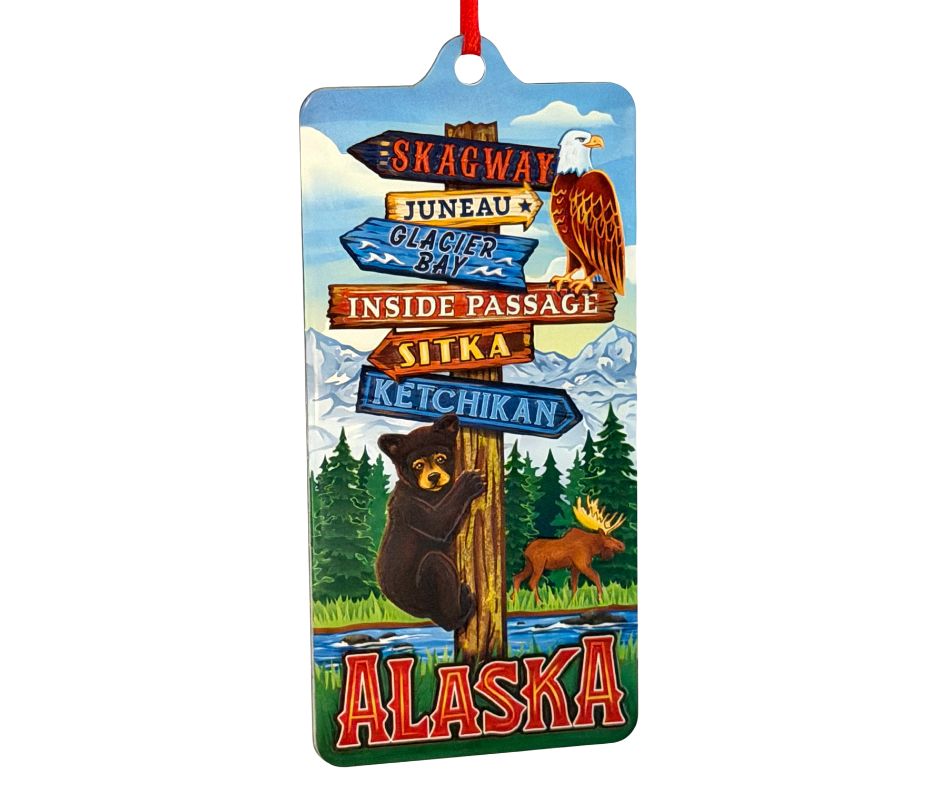 Decorative ornament featuring Inside Passage cities on a signpost as a bear is climbing it. 