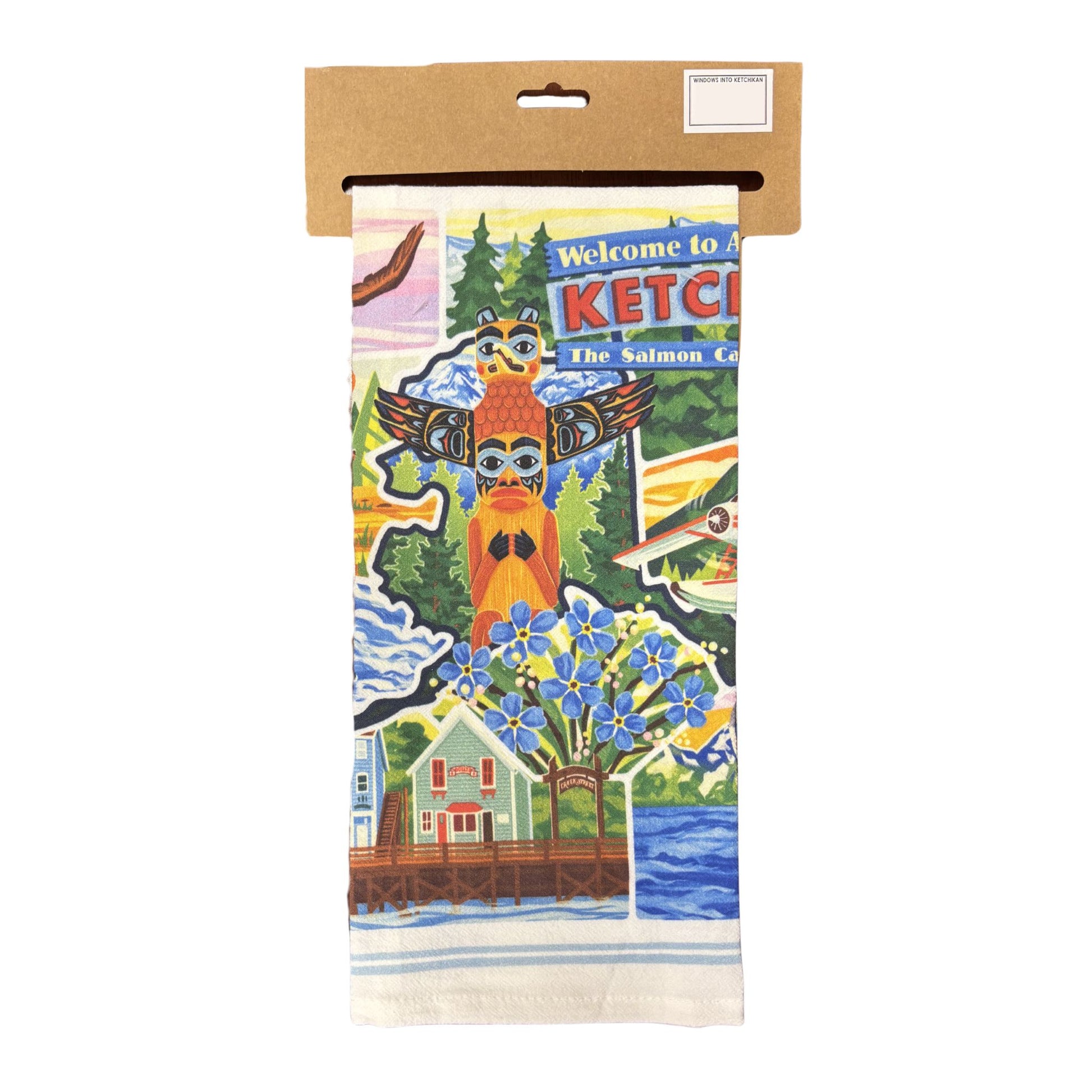 Kitchen towel with a colorful design featuring a totem pole, and ketchikan themed designs