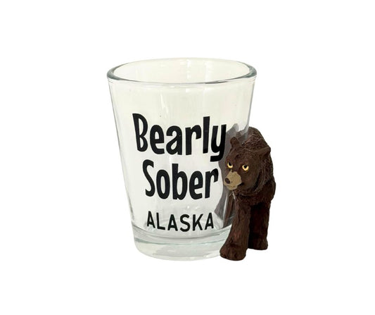 Shot glass with 'Bearly Sober Alaska' text and a bear figurine on a white background