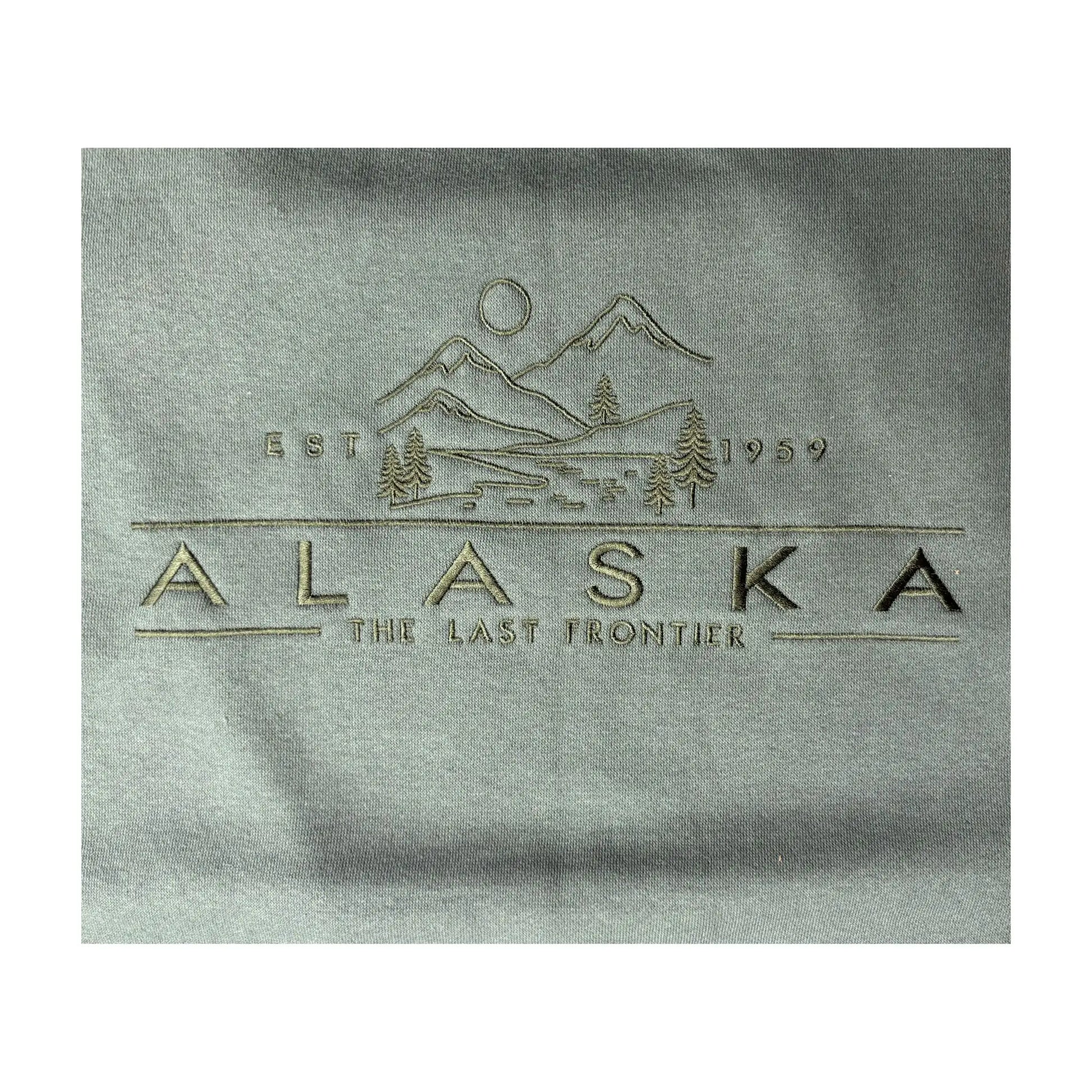 Close-up detail of green alaska crewneck