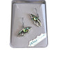 orca shaped earrings in a 'Wild Pearle' box on a white background