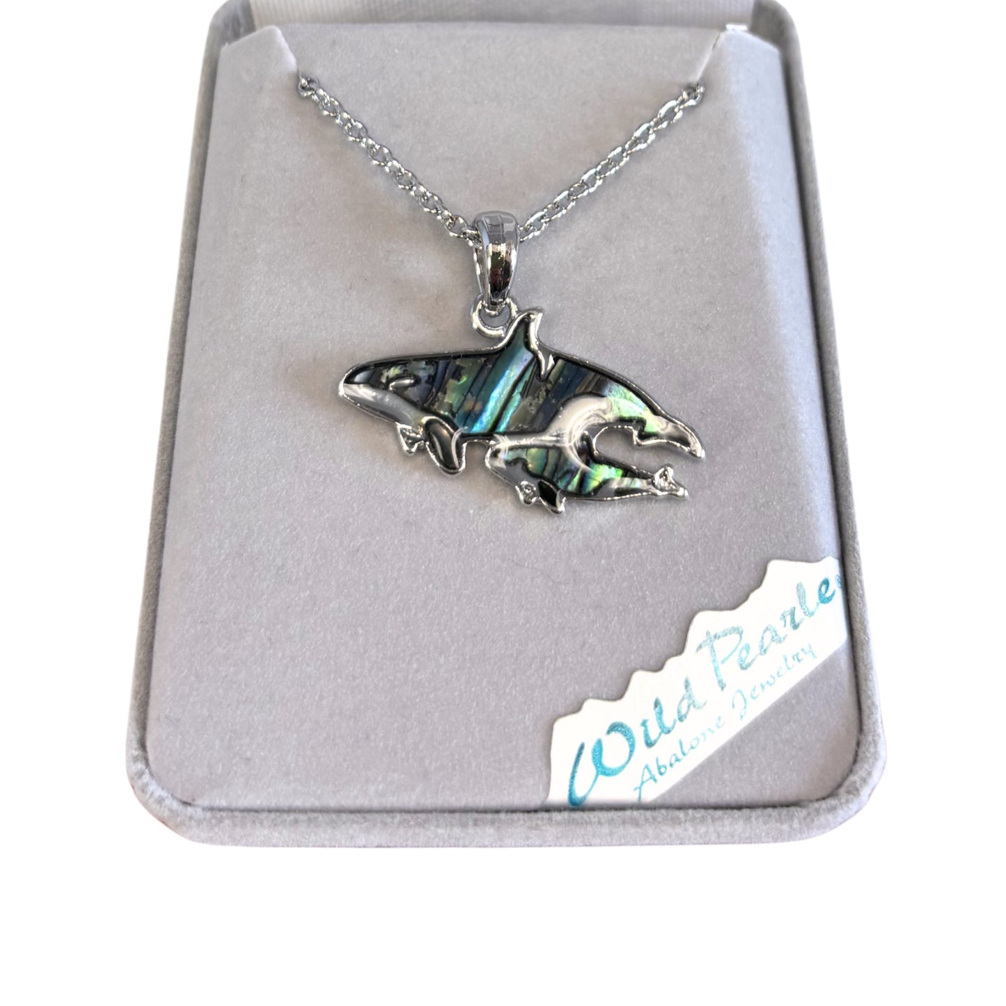 Silver orca pendant necklace in a jewelry box with 'Wild Pearle' branding.