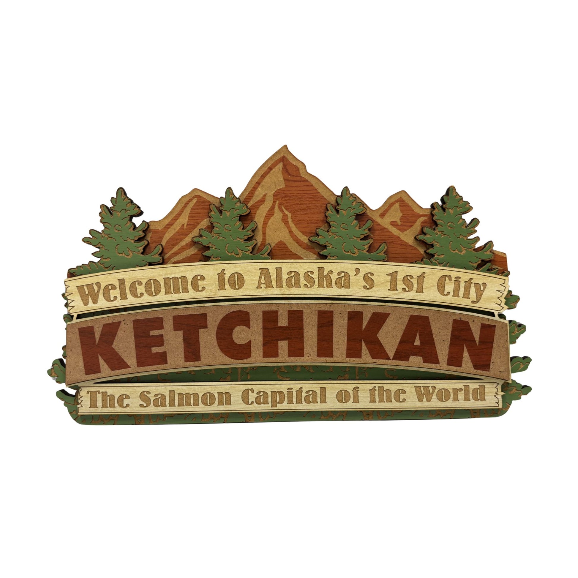 Decorative sign with mountain and tree design, featuring text about Ketchikan, Alaska.