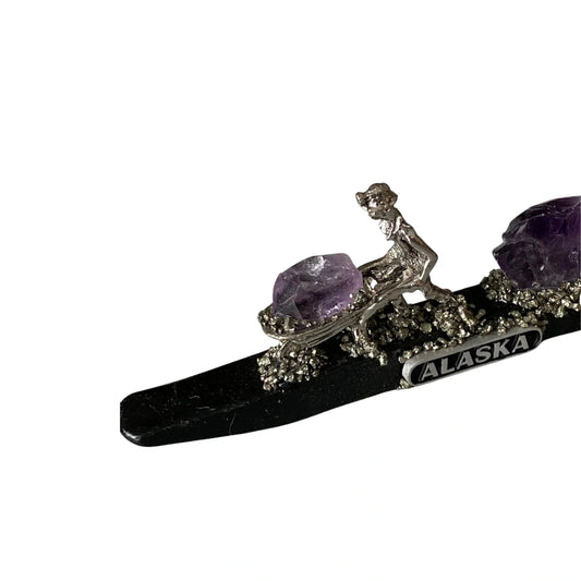 Decorative item with purple gemstones and 'Alaska' text on a white background