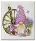 Eco dishcloth with Gnome with a purple hat and lavender flowers next to a wooden wheel 