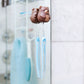 Bear-shaped toothbrush holder with a blue toothbrush on a bathroom mirror.