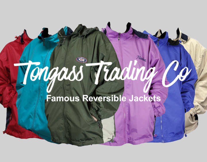 Colorful reversible jackets displayed with Tongass Trading Co branding on a gray background