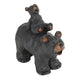 Two bear figurines, one standing and one sitting on the back of the other, against a white background.