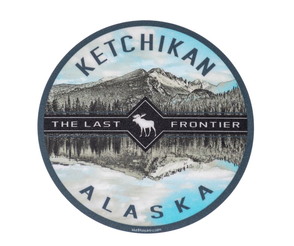 Round sticker with Ketchikan, Alaska text with mountain landscape